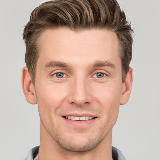 Joyful white young-adult male with short  brown hair and grey eyes