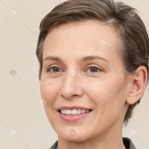 Joyful white adult female with medium  brown hair and grey eyes