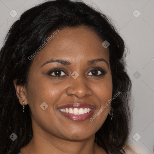 Joyful black young-adult female with long  brown hair and brown eyes