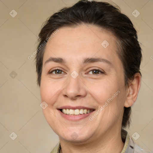 Joyful white adult female with medium  brown hair and brown eyes