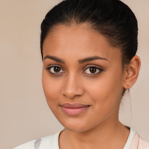 Joyful latino young-adult female with long  brown hair and brown eyes