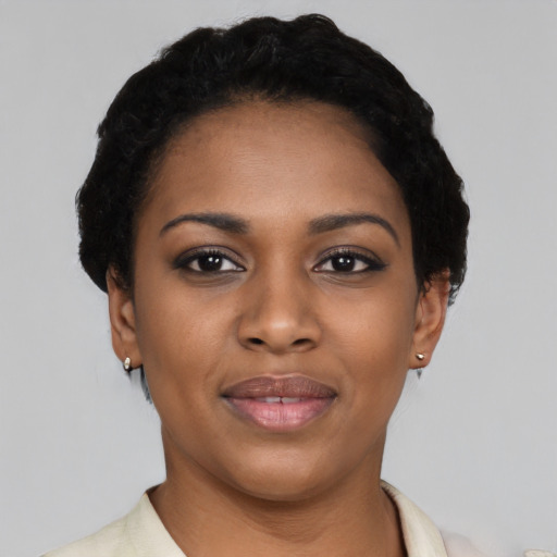 Joyful black young-adult female with short  black hair and brown eyes