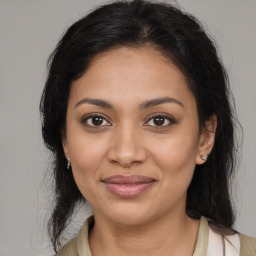 Joyful latino young-adult female with medium  brown hair and brown eyes