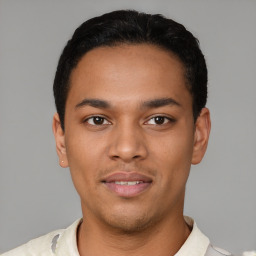 Joyful latino young-adult male with short  black hair and brown eyes