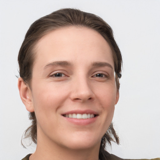 Joyful white young-adult female with medium  brown hair and grey eyes