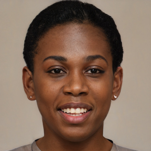Joyful black young-adult female with short  black hair and brown eyes