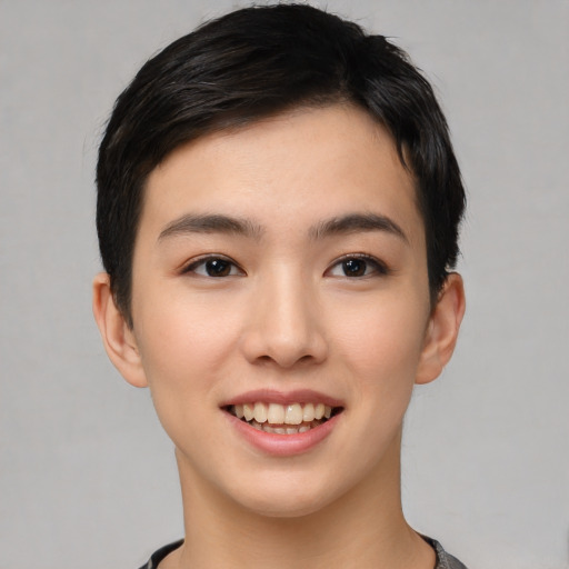 Joyful asian young-adult female with short  black hair and brown eyes