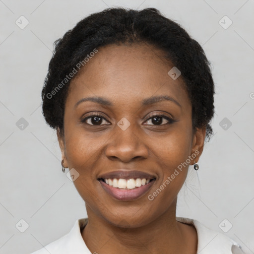 Joyful black young-adult female with short  black hair and brown eyes