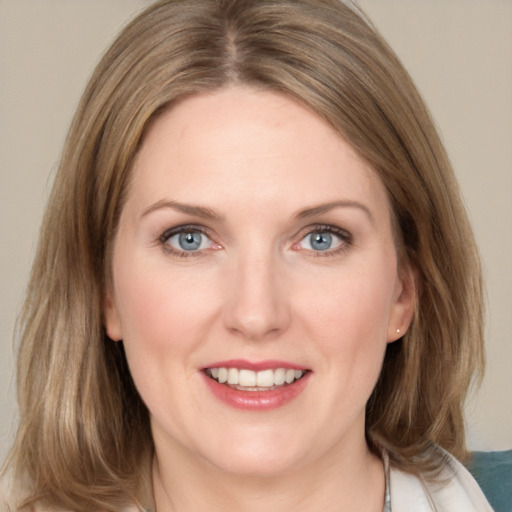 Joyful white young-adult female with medium  brown hair and blue eyes