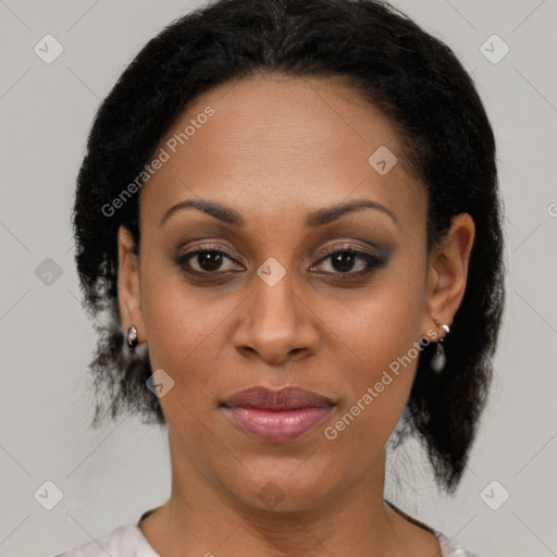 Joyful black adult female with medium  brown hair and brown eyes