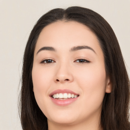 Joyful asian young-adult female with long  brown hair and brown eyes