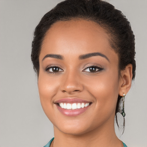 Joyful latino young-adult female with long  brown hair and brown eyes