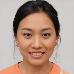 Joyful asian young-adult female with medium  brown hair and brown eyes