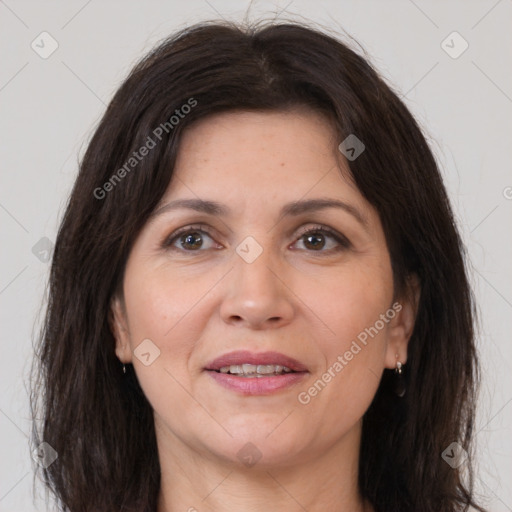 Joyful white adult female with long  brown hair and brown eyes