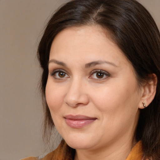 Joyful white adult female with medium  brown hair and brown eyes