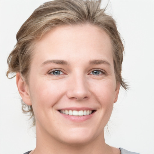 Joyful white young-adult female with medium  brown hair and grey eyes