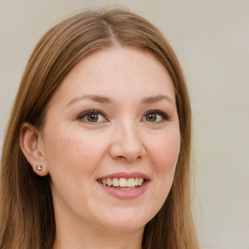 Joyful white young-adult female with long  brown hair and brown eyes