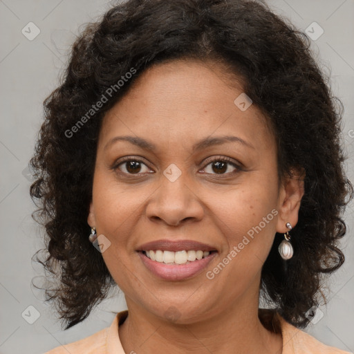 Joyful black adult female with medium  brown hair and brown eyes