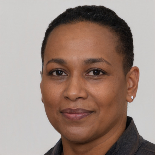 Joyful black adult female with short  black hair and brown eyes