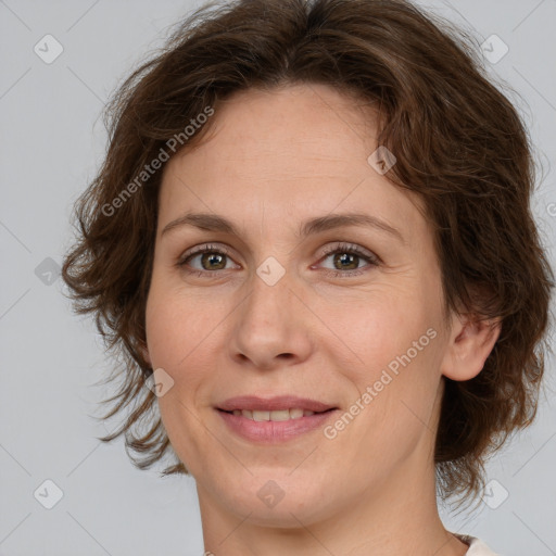 Joyful white adult female with medium  brown hair and green eyes