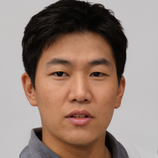 Neutral asian young-adult male with short  brown hair and brown eyes