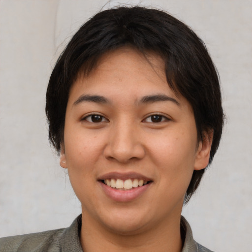 Joyful latino young-adult female with short  brown hair and brown eyes