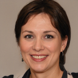 Joyful white adult female with medium  brown hair and brown eyes