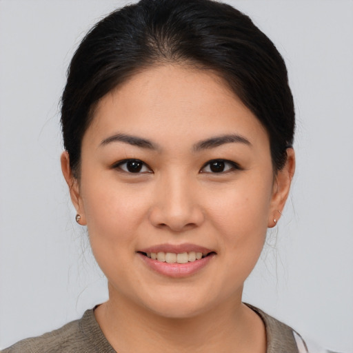 Joyful asian young-adult female with medium  brown hair and brown eyes
