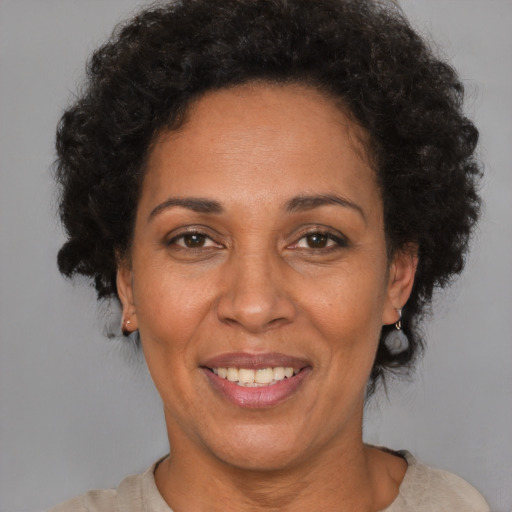 Joyful latino adult female with short  brown hair and brown eyes
