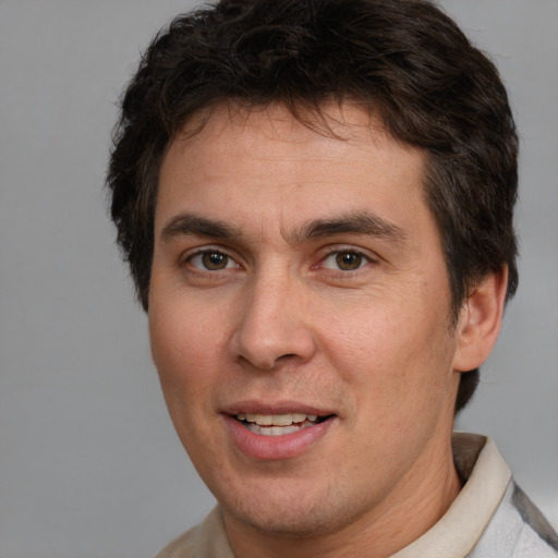 Joyful white adult male with short  brown hair and brown eyes