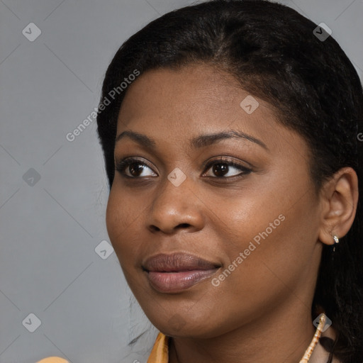 Joyful black young-adult female with long  black hair and brown eyes