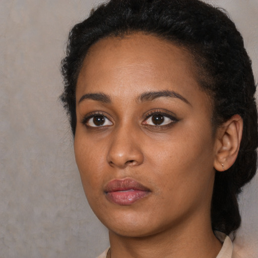 Neutral black young-adult female with short  black hair and brown eyes