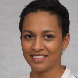 Joyful latino young-adult female with short  brown hair and brown eyes