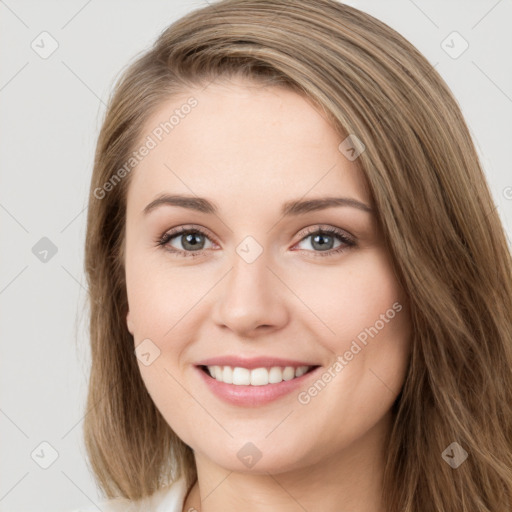 Joyful white young-adult female with long  brown hair and green eyes