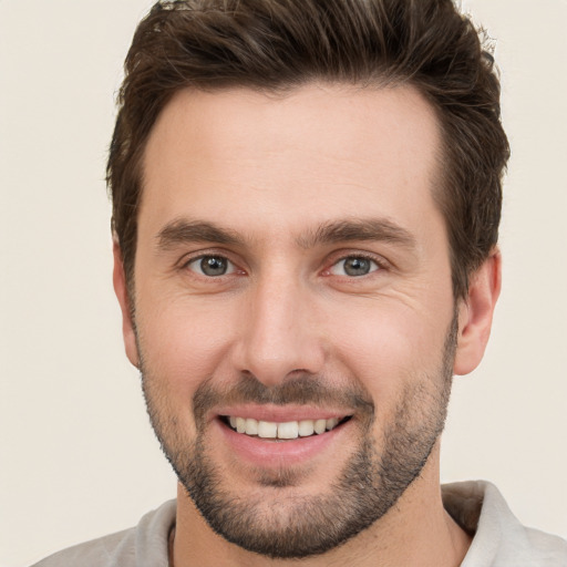 Joyful white young-adult male with short  brown hair and brown eyes