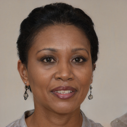 Joyful black adult female with short  brown hair and brown eyes