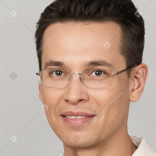 Joyful white adult male with short  brown hair and brown eyes