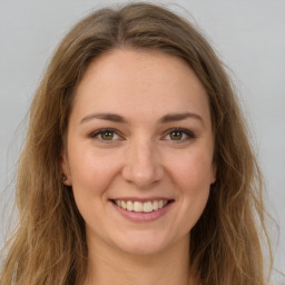 Joyful white young-adult female with long  brown hair and green eyes