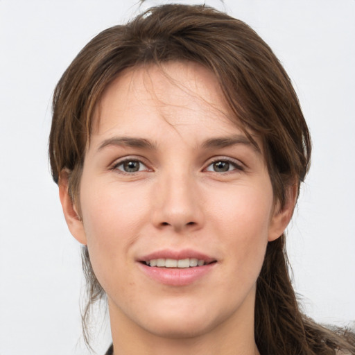 Joyful white young-adult female with long  brown hair and grey eyes