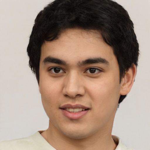Joyful white young-adult male with short  black hair and brown eyes