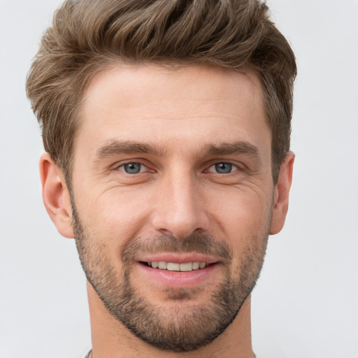 Joyful white young-adult male with short  brown hair and grey eyes