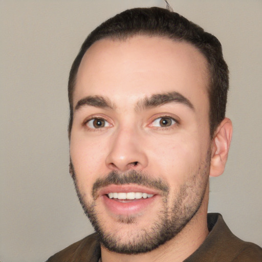 Joyful white young-adult male with short  black hair and brown eyes