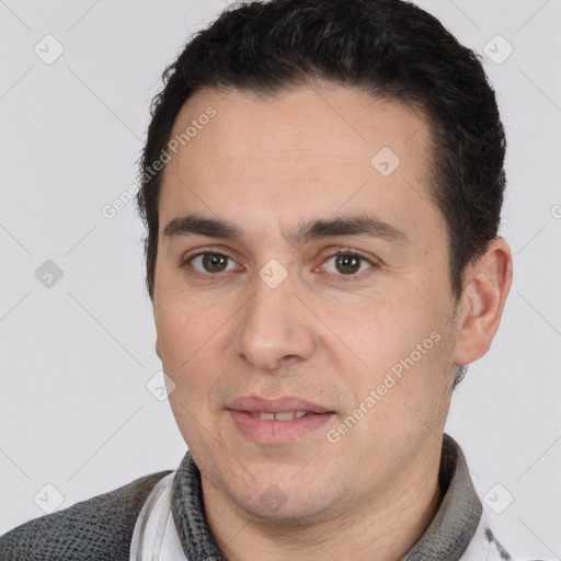 Joyful white young-adult male with short  black hair and brown eyes