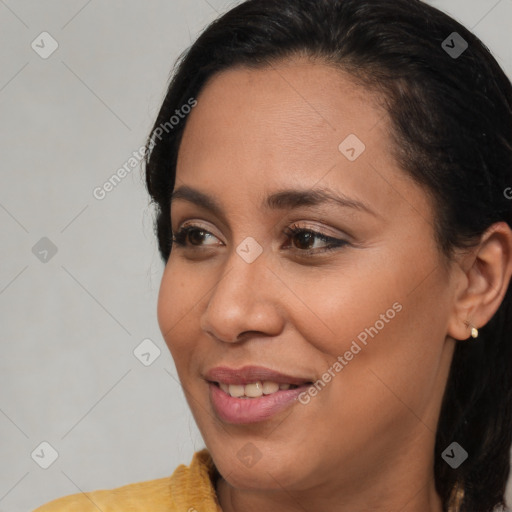 Joyful black young-adult female with medium  brown hair and brown eyes