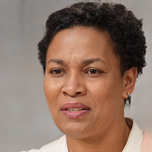 Joyful black adult female with short  brown hair and brown eyes