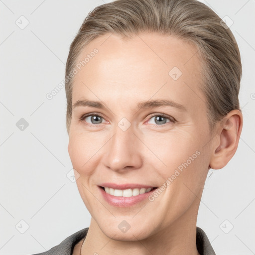 Joyful white young-adult female with short  brown hair and grey eyes