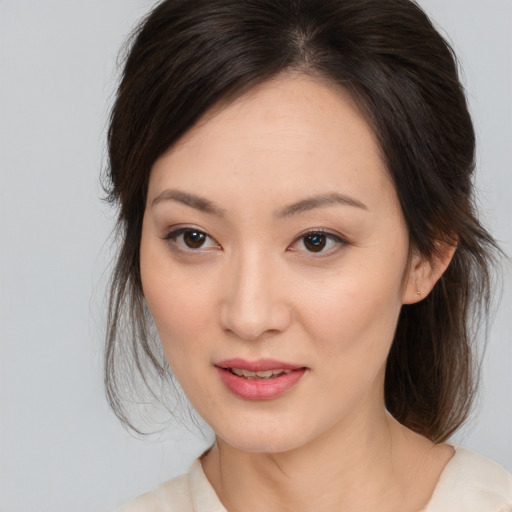 Joyful white young-adult female with medium  brown hair and brown eyes