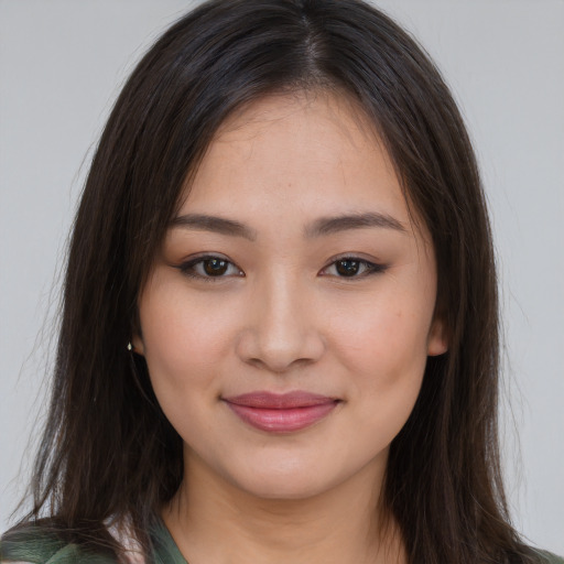 Joyful asian young-adult female with long  brown hair and brown eyes