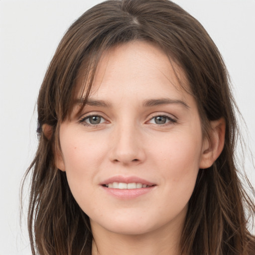 Joyful white young-adult female with long  brown hair and grey eyes