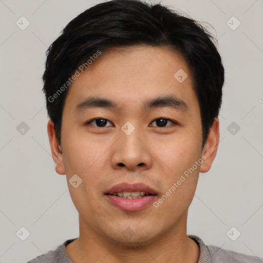 Joyful asian young-adult male with short  black hair and brown eyes